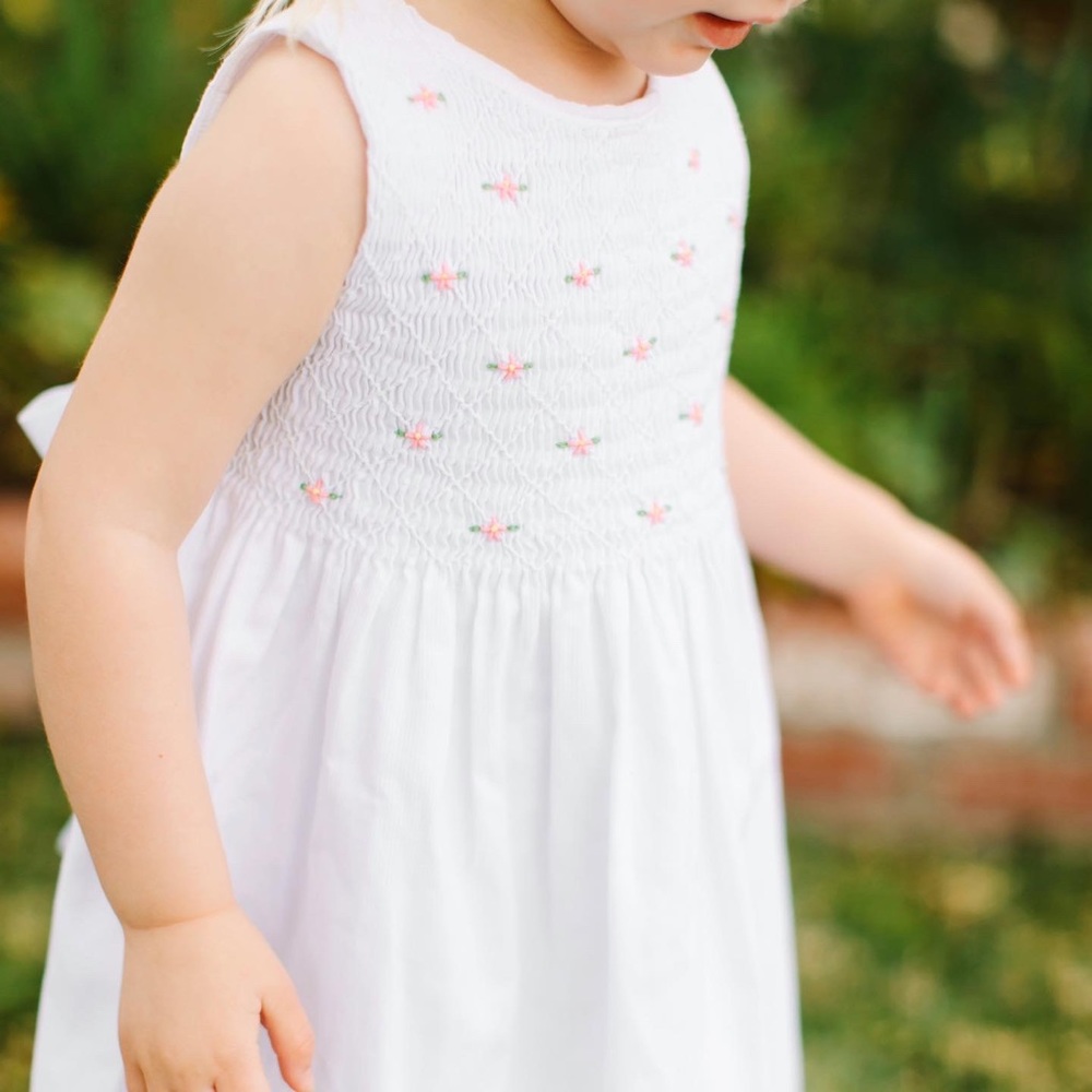 Vintage Kru Little smocked top dress with embroidered flowers and tie back.
